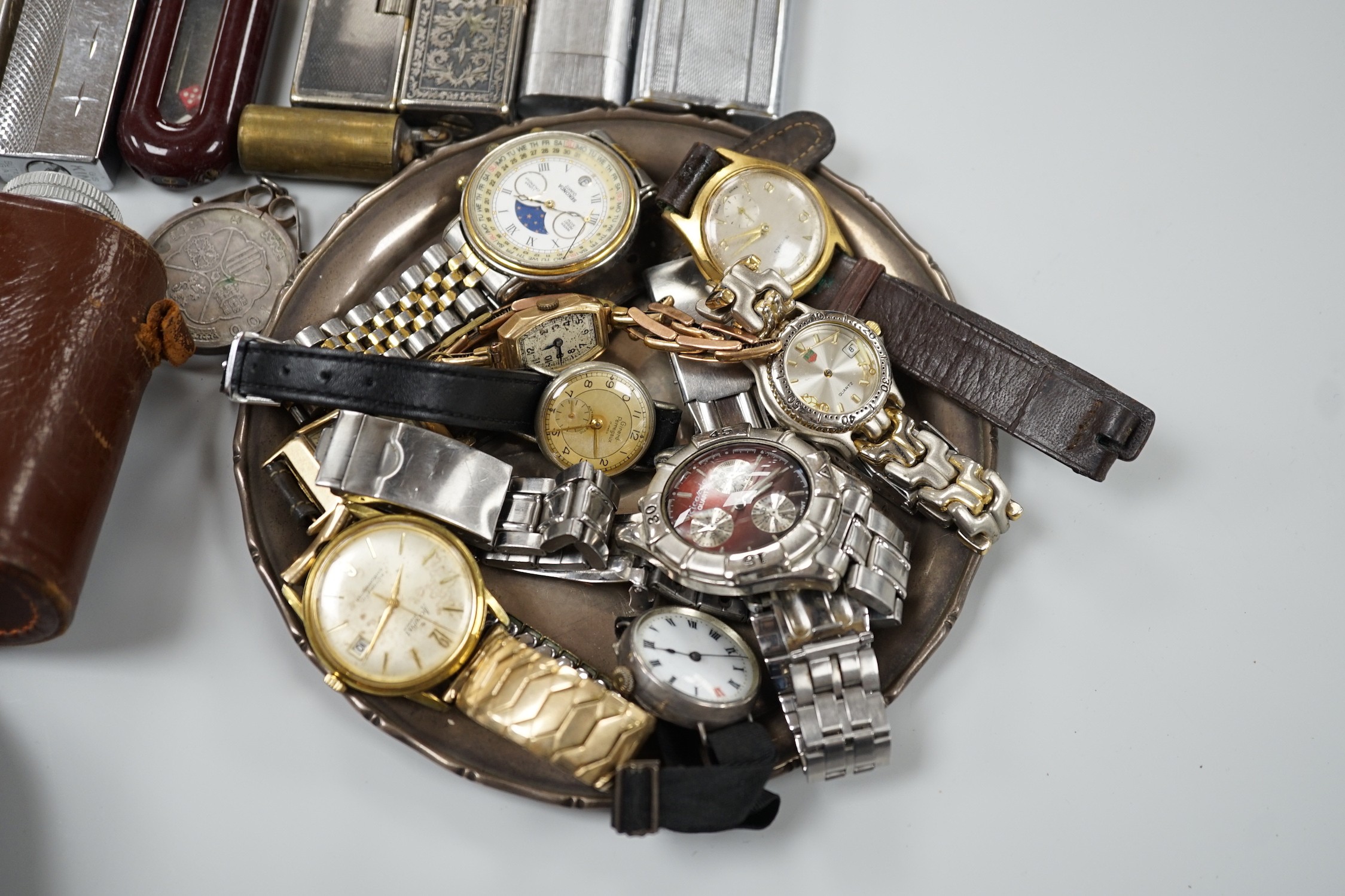 A collection of mixed wristwatches and cigarette lighters and a camera